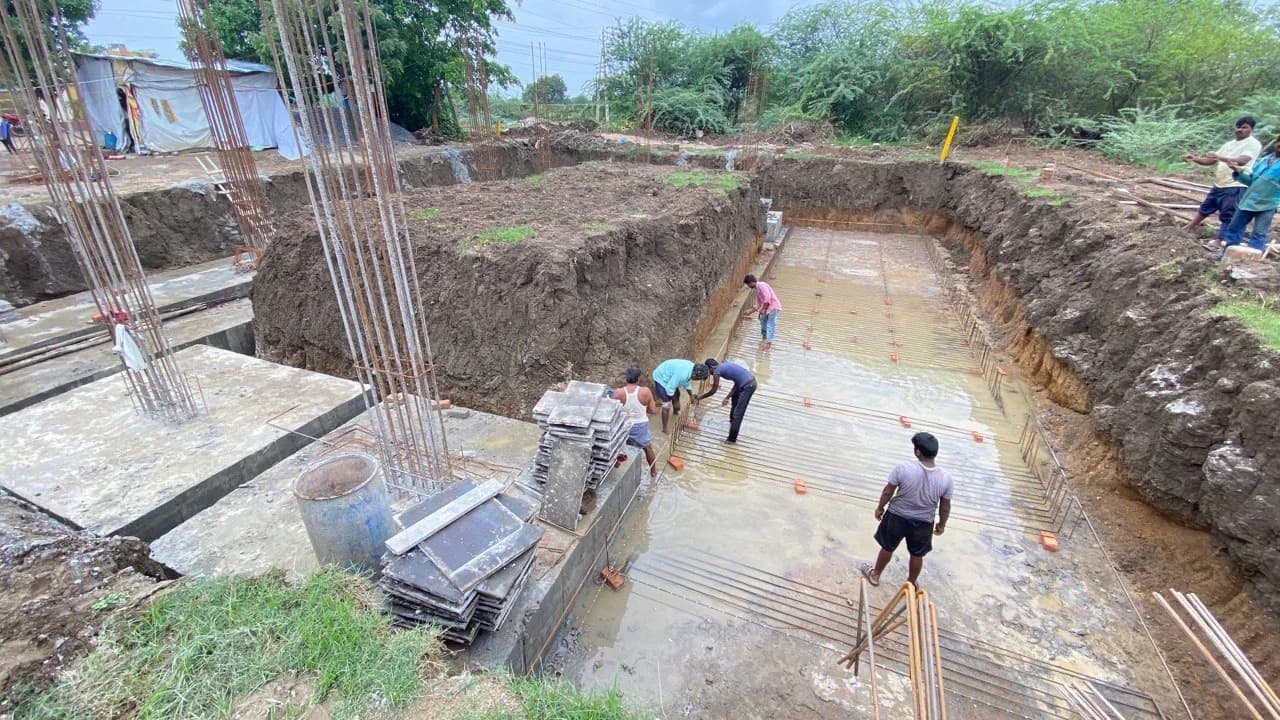 Workers in the excavated foundation trench at the church site