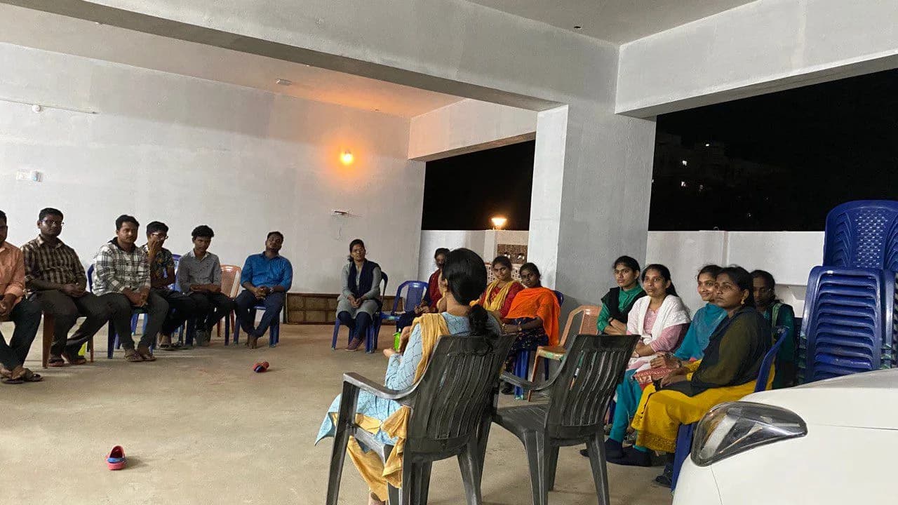 An evening service with the congregation seated together in the hall